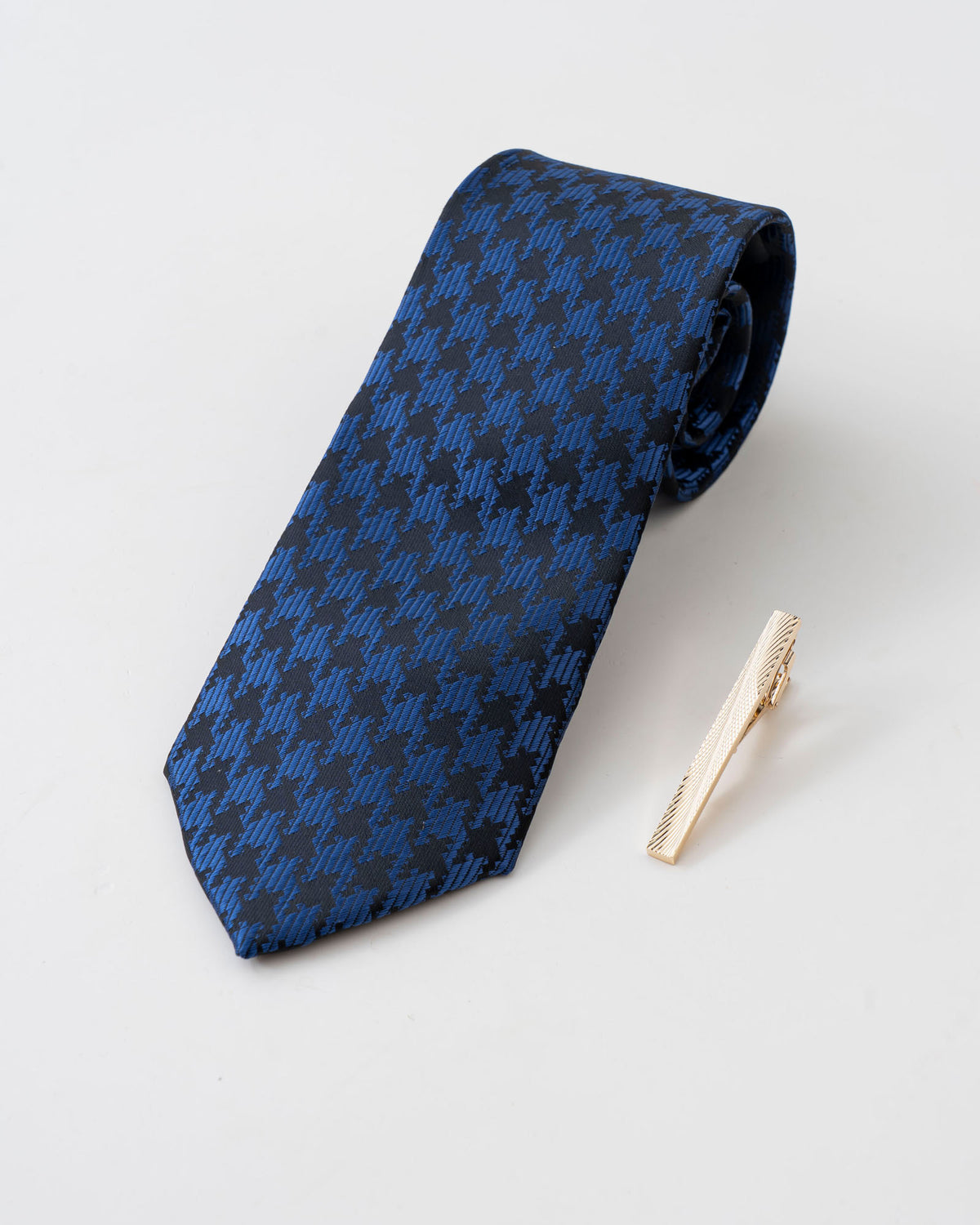 Gold-tone tie clip close-up