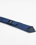 Blue and black patterned tie laid flat showing the back detail