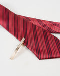 Diamond-textured tie clip shown with a red patterned tie