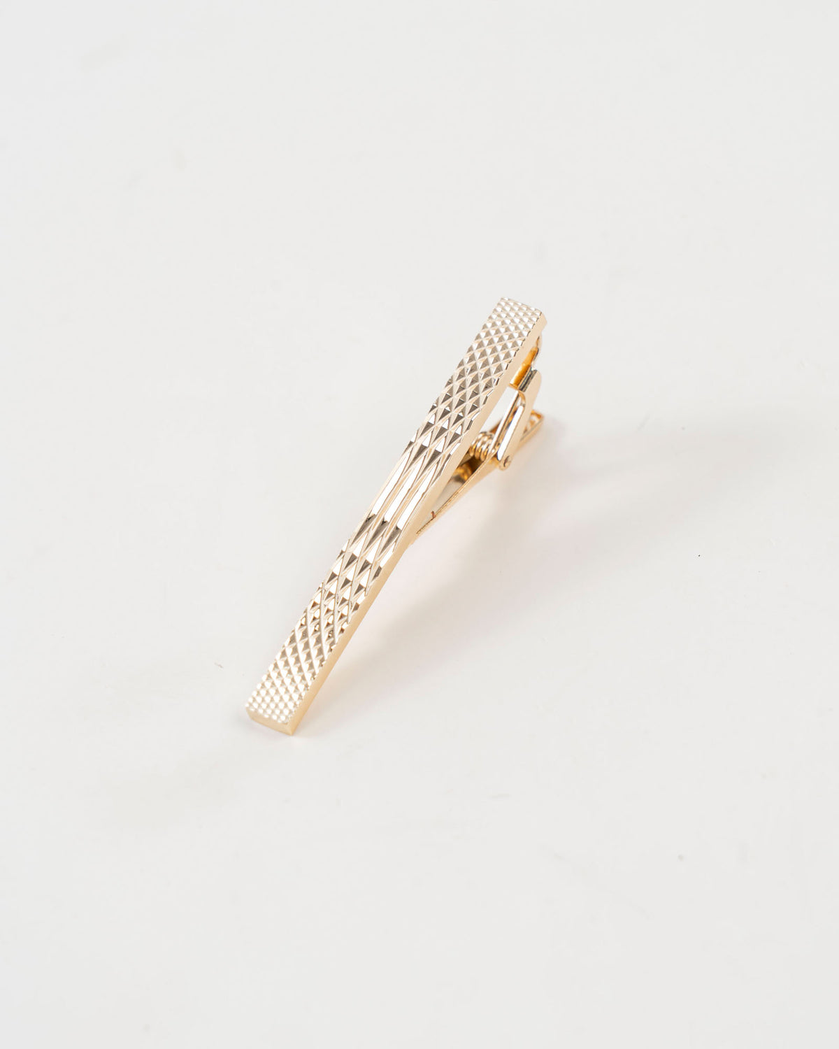 Diamond-textured tie clip close-up