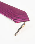Black stripe gold-tone tie clip shown with a patterned tie