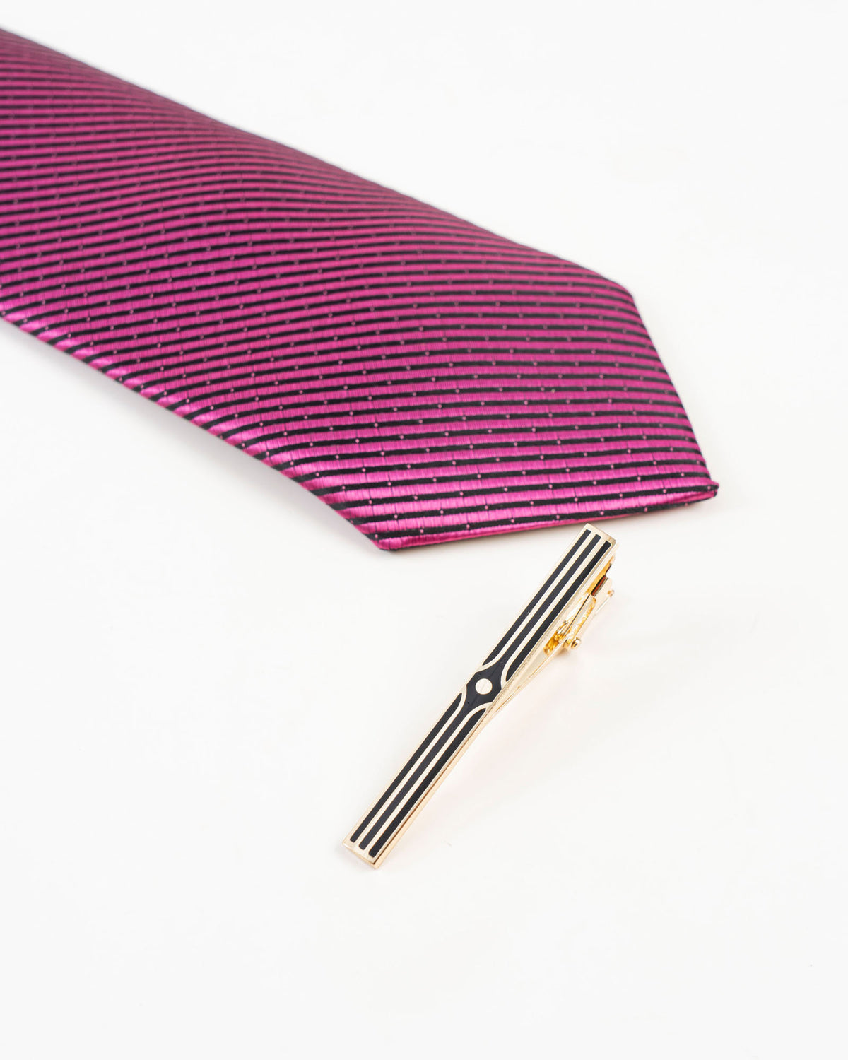 Black stripe gold-tone tie clip shown with a patterned tie
