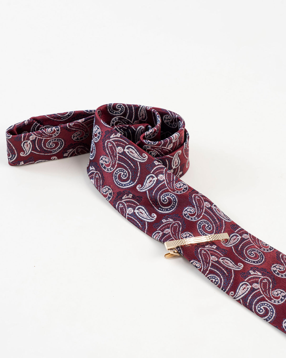 Diamond-textured tie clip paired with a burgundy paisley tie