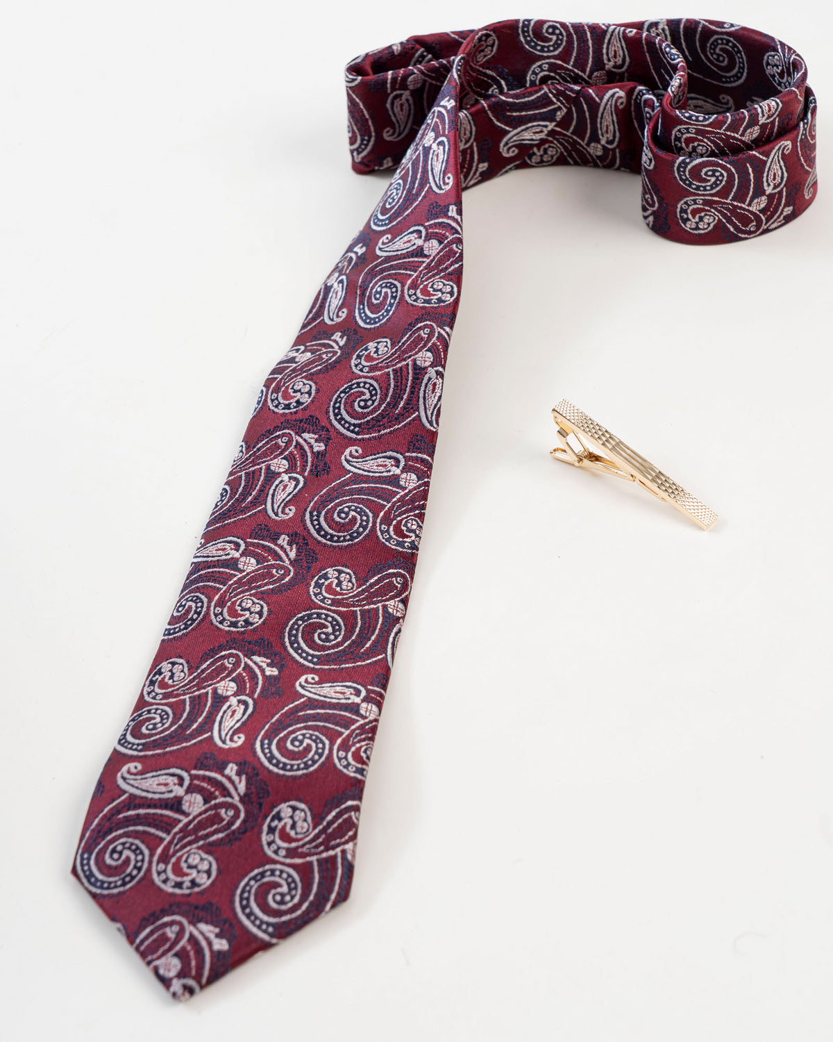 Diamond-textured gold-tone tie clip close-up