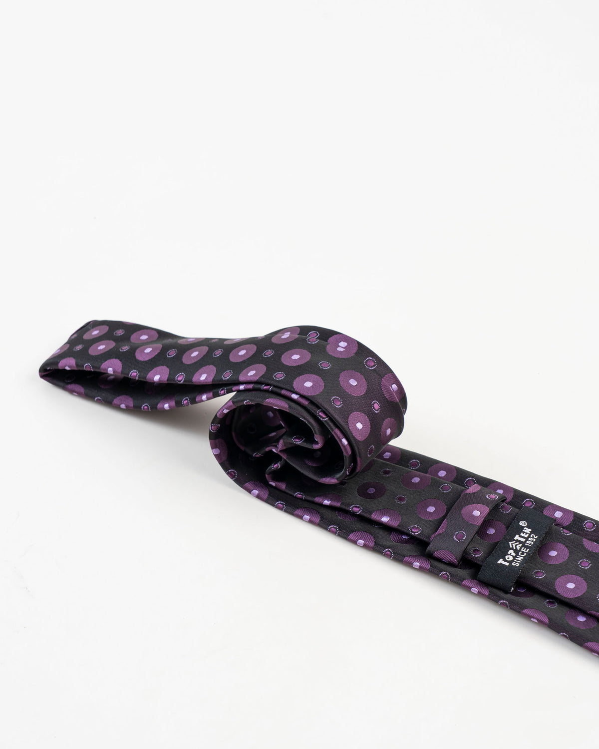 Full view of black and purple circular patterned tie
