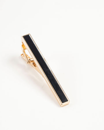 Black enamel-style gold-tone tie clip close-up